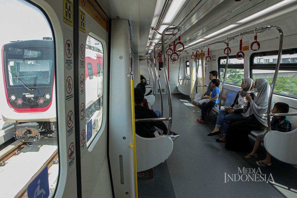 Penumpang menggunakan moda transportasi Kereta Lintas Raya Terpadu (LRT) jurusan Stasiun Velodrome Rawamangun menuju Stasiun Pegangsaan 2, Jakarta.