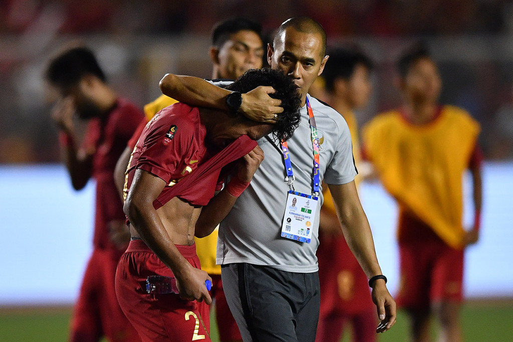 Asisten pelatih Timnas U-22 Indonesia Kurniawan Dwi Yulianto (kanan) menghibur pesepak bola Osvaldo Haay (kiri) seusai kalah dari Timnas Vietnam dalam final sepak bola putra SEA Games 2019 di Stadion Rizal Memorial, Manila, Filipina.
