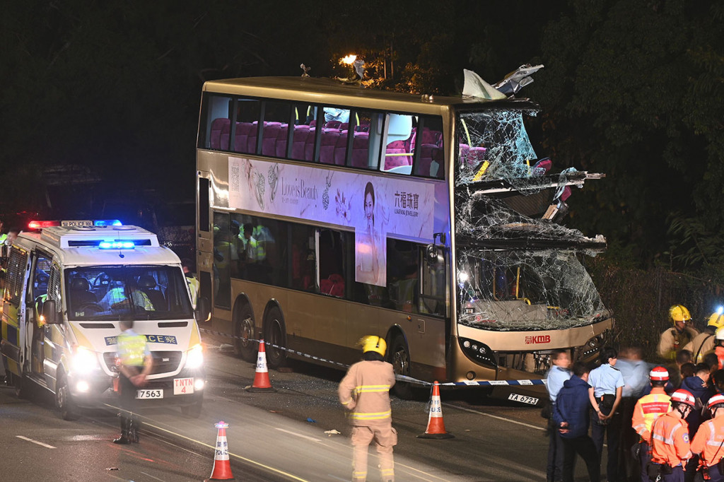 Petugas pemadam kebakaran, tim medis, dan polisi berkumpul di dekat bus tingkat yang mengalami kecelakaan di Kwu Tung, Hong Kong, Rabu, 18 Desember 2019 malam.