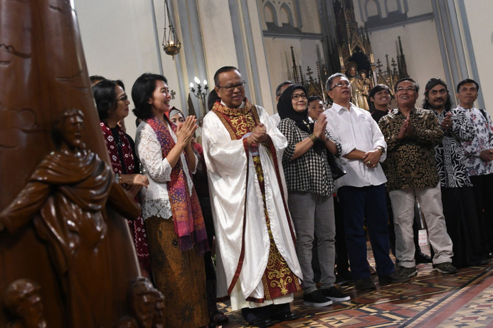 Sejumlah anggota komunitas lintas agama berdoa bersama saat mengunjungi ibadah Misa Natal di Gereja Katedral, Jakarta, Rabu, 25 Desember 2019. 