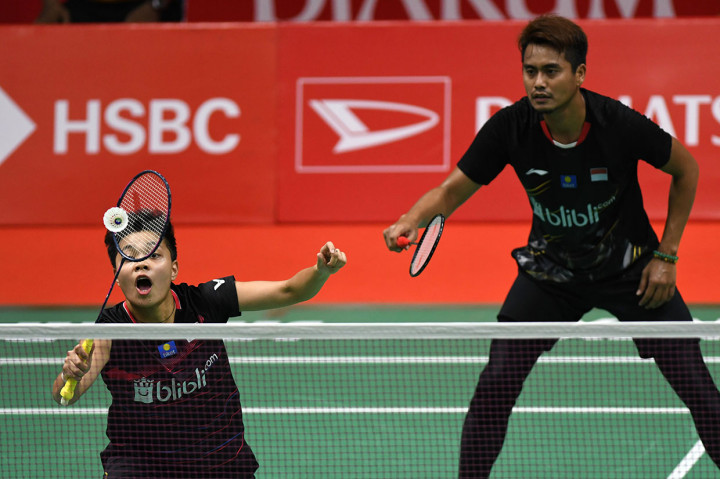 Pebulu tangkis ganda campuran Indonesia Tontowi Ahmad (kanan) dan Apriyani Rahayu mengembalikan kok ke arah pebulu tangkis ganda campuran Thailand Supak Jomkoh dan Supissara Paewsampran saat pertandingan putaran pertama (32 besar) Daihatsu Indonesia Masters 2020 di Istora Senayan, Jakarta. 
