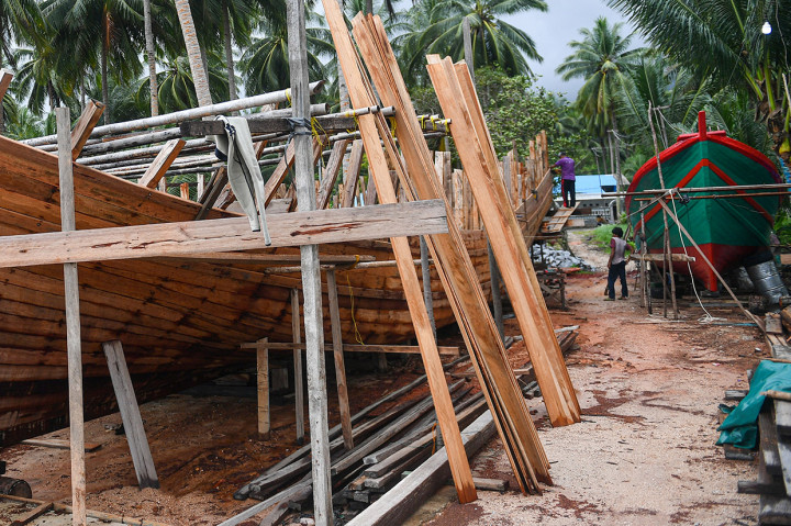 Pekerja menyelesaikan pembuatan kapal motor di Desa Tanjung, Natuna, Kepulauan Riau. 