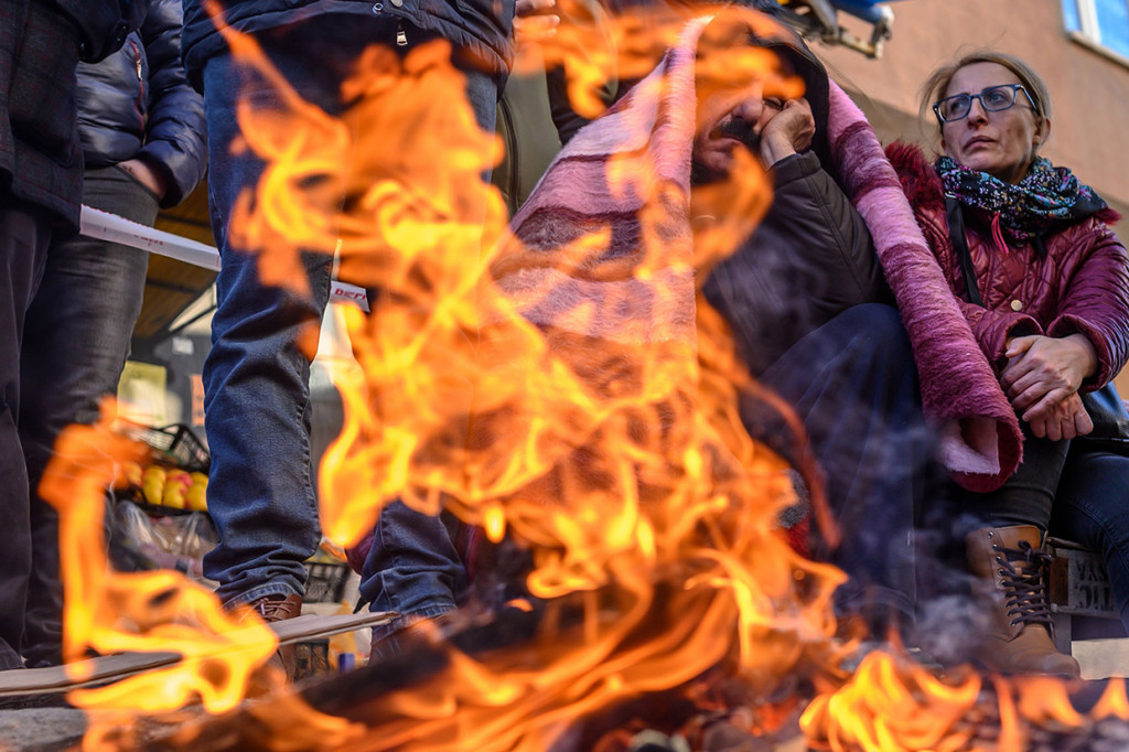 Para korban selamat membuat perapian untuk menghangatkan tubuh mereka.