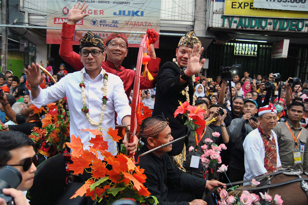 Menteri Pariwisata dan Ekonomi Kreatif Wishnutama (kiri) bersama Gubernur Jawa Barat Ridwan Kamil (tengah) dan Wali Kota Bogor Bima Arya menaiki delman saat pawai budaya Bogor Street Festival Cap Go Meh 2020 di Jalan Suryakencana, Kota Bogor, Jawa Barat. ANTARA FOTO/Arif Firmansyah