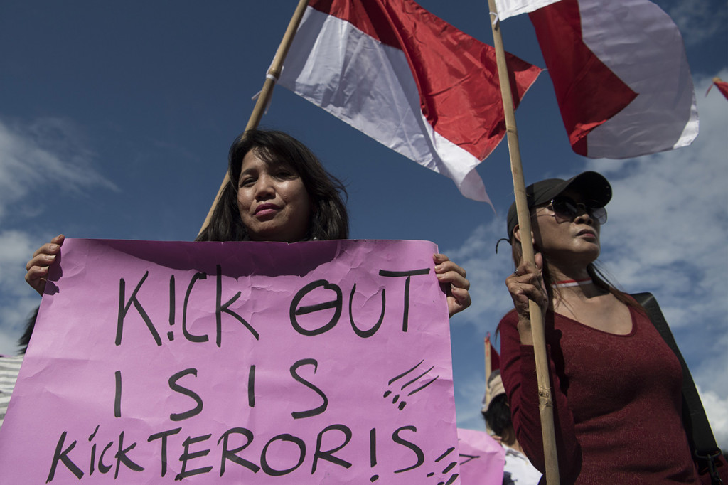 Peserta membawa poster bertuliskan 'Kick Out ISIS, Kick Teroris' saat berunjuk rasa di depan Istana Merdeka Jakarta.