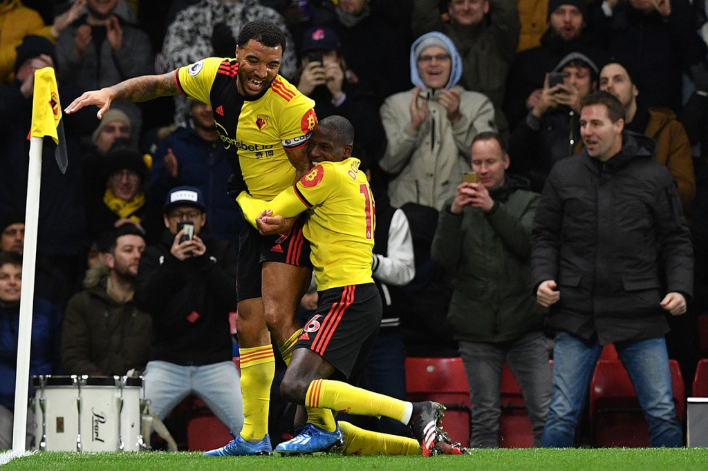 Troy Deeney melakukan selebrasi usai mencetak gol ke gawang Liverpool.
