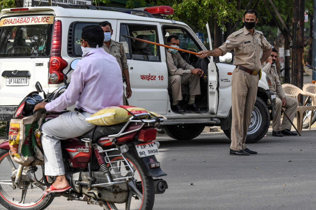 Namun masih ada warga yang beraktivitas dengan tetap berpergian ke pasar dan menggunakan transportasi umum. AFP Photo/Prakash Singh
