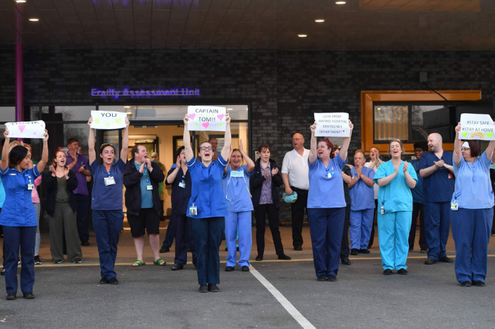 Aksi penggalangan dana oleh Tom Moore tersebut mendapat sambutan haru dari para pegawai National Health Service (NHS) dan staf medis garis depan dalam penanganan pandemi covid-19, di Aintree University Hospital, Liverpool. 