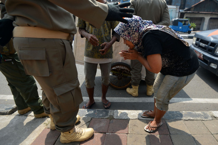 Warga penyandang masalah kesejahteraan sosial (PMKS) memohon untuk tidak diamankan petugas Satpol PP di Jalan Dewi Sartika, Cawang, Jakarta Timur.
