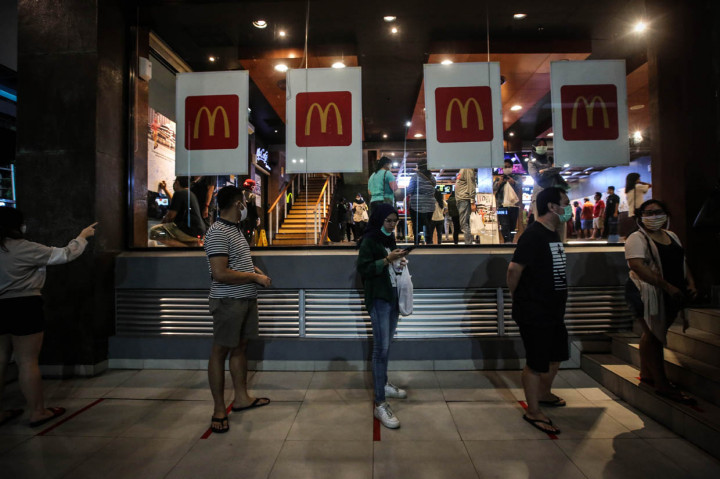 Petugas keamanaan mencoba mengatur para pengunjung ajar tetap menjaga jarak aman atau physical distancing.