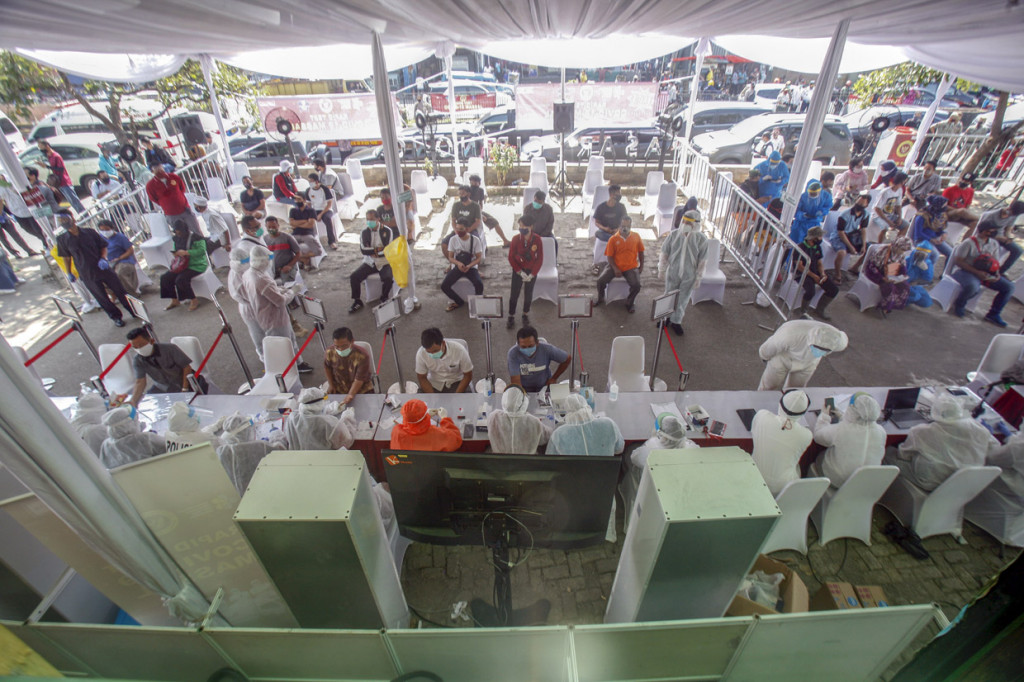 Petugas medis mengambil sampel darah warga saat rapid test massal di Cibinong, Bogor, Jawa Barat.