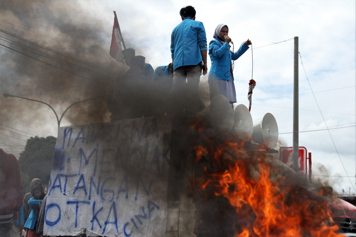 Mahasiswa melakukan orasi dan membakar ban bekas di areal pintu masuk Bandar Udara Haluoleo di jalan Wolter Mongonsidi, Kecamatan Ranomeeto, Konawe Selatan, Sulawesi Tenggara, Selasa, 23 Juni 2020.