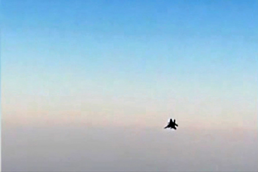 Gambar dari video yang dirilis oleh kantor berita Iran, Press menunjukkan sebuah jet tempur terlihat dari sebuah jendela pesawat penumpang Iran saat terbang di atas Suriah. Belakangan diketahui jet tempur tersebut merupakan milik AS.