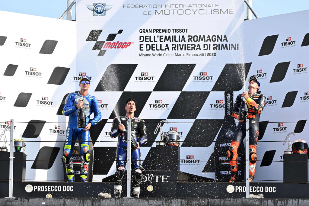 Maverick Vinales, Joan Mir, dan Pol Espargaro melakukan selebrasi di podium dengan sampanye usai pertandingan MotoGP Emilia Romagna 2020.  