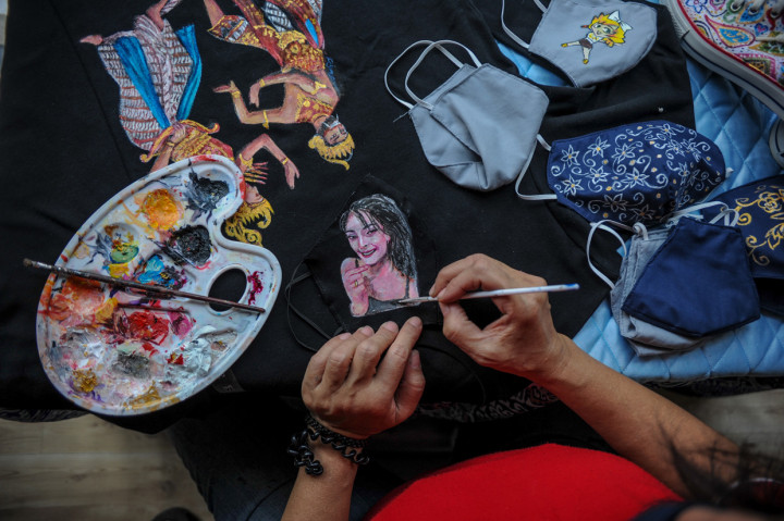 Seorang warga binaan pemasyarakatan perempuan melukis masker di sarana asimilasi dan edukasi usai diresmikan di Lapas Perempuan Kelas II A Bandung, Jawa Barat.