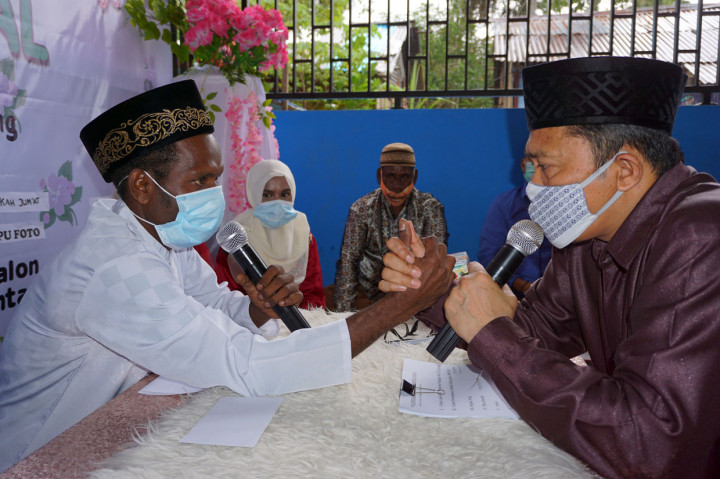 Petugas pencatat nikah Kantor Urusan Agama (KUA) sekaligus penghulu (kanan) melakukan proses Ijab Kabul terhadap pasangan pengantin di Kota Sorong, Papua Barat.
