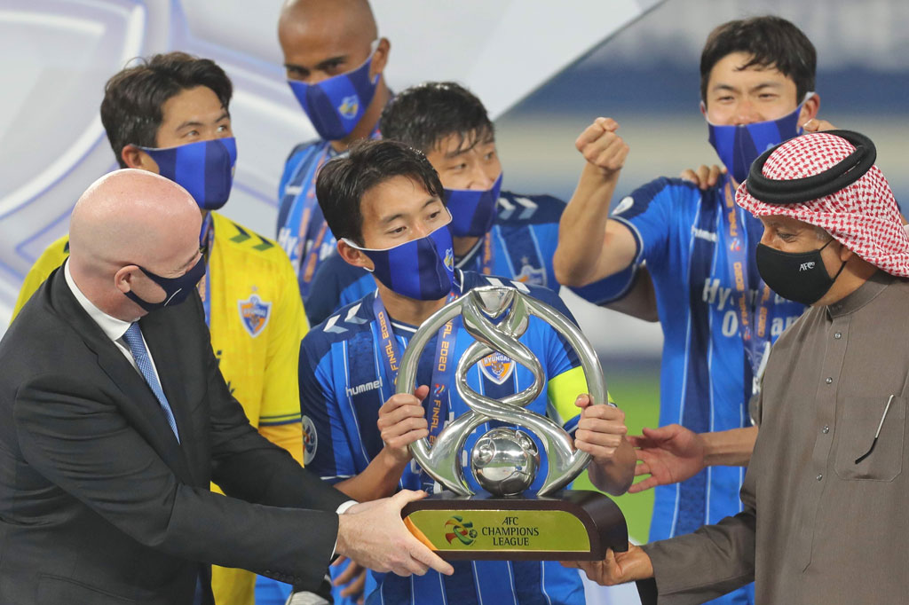 Presiden FIFA Gianni Infantino (kiri) bersama Presiden AFP Sheikh Salman bin Ebrahim Al Khalifa menyerahkan trofi Liga Champions Asia 2020 kepada kapten tim Ulsan Hyundai di Stadion Al-Janoub di Kota Al Wakrah, Qatar, Sabtu, 19 Desember 2020.