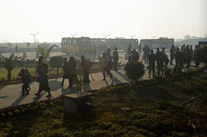 Pengungsi Rohingya berjalan dengan barang-barang mereka untuk menaiki kapal Angkatan Laut Bangladesh saat mereka akan dipindahkan ke Pulau Bhashan Char di Teluk Bengal, Chittagong pada Jumat, 29 Januari 2021.