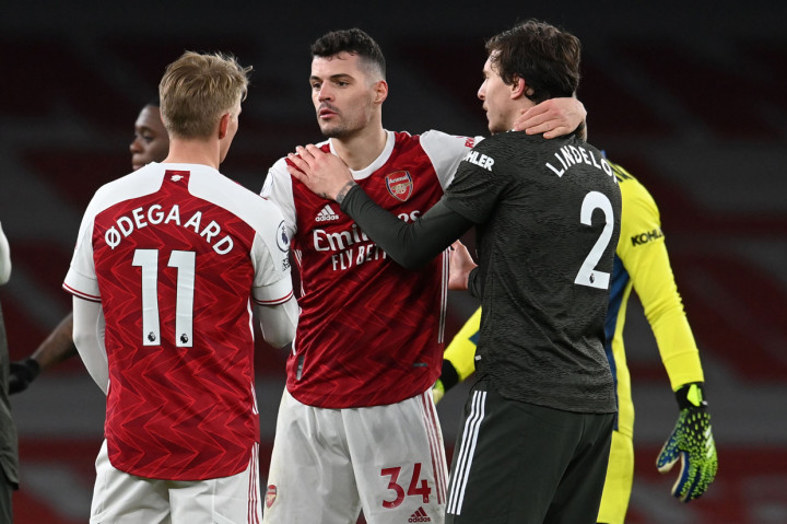 Arsenal dan Manchester United harus puas berbagi poin dalam pertemuan di Emirates Stadium dalam laga pekan ke-21 Premier League. AFP Photo/Andy Rain