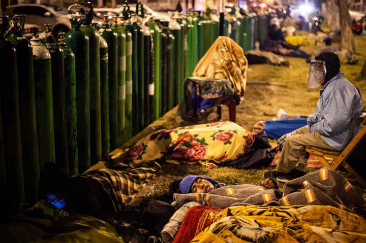 Warga rela tidur di jalanan saat mengantre untuk mengisi ulang tabung oksigen di Callao, Peru, akhir pekan lalu. Merebaknya wabah covid-19 di Peru berdampak kurangnya ketersediaan oksigen.