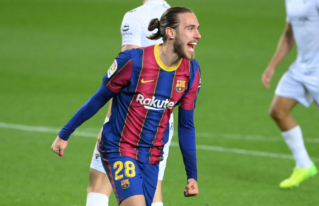 Oscar Mingueza melakukan selebrasi usai mencetak gol ke gawang Huesca.