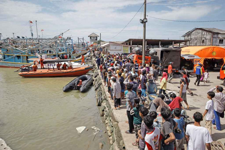 Warga berkerumun di pinggir dermaga sambil menunggu kejelasan keluarga mereka yang hilang akibat kecelakaan laut di perairan Kabupaten Indramayu, Jawa Barat, Sabtu, 3 April 2021.