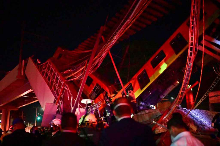Petugas penyelamat berada di lokasi kecelakaan kereta metro setelah jembatan layang untuk metro runtuh sebagian di Mexico City pada Senin, 3 Mei 2021 waktu setempat.