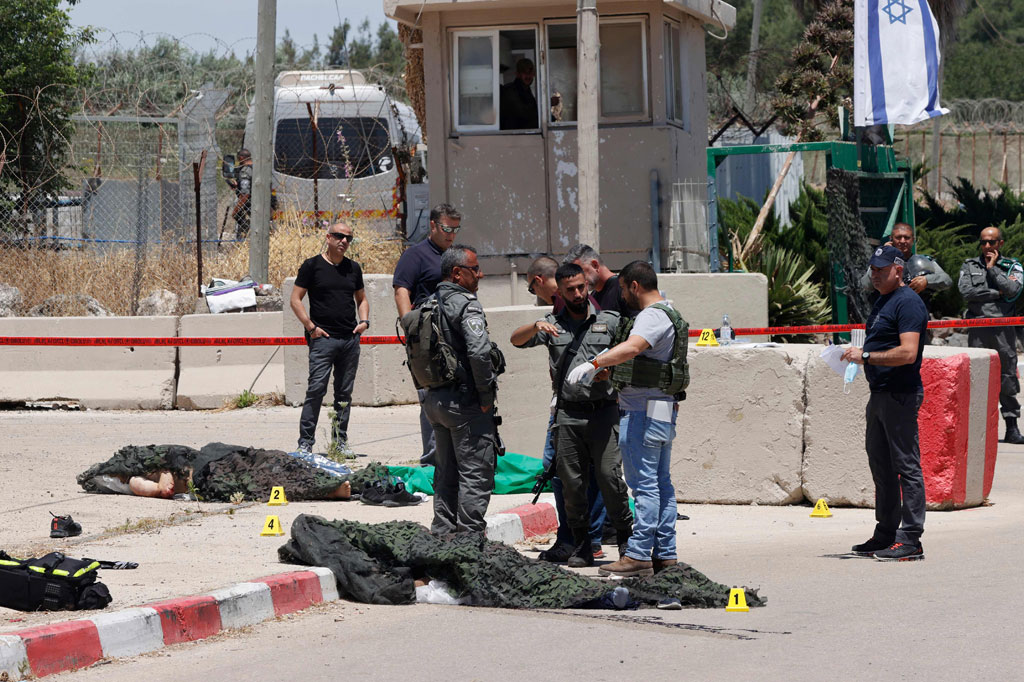 Petugas memeriksa dua warga Palestina yang ditembak mati oleh pasukan keamanan Israel di depan pangkalan militer Salem dekat Kota Jenin, Tepi Barat, pada Jumat, 7 Mei 2021.