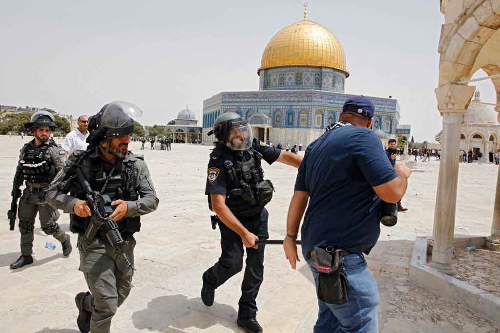 Terlihat Ahmed Gharabli digiring oleh dua orang petugas keamanan Israel. Satu petugas memukul Gharabli, sementara satu lainnya menenteng senjata laras panjang.