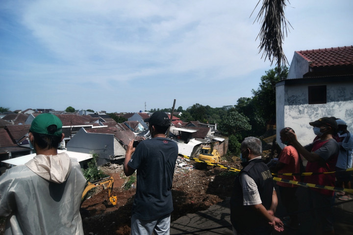 Sejumlah warga melihat longsor yang menimpa rumah warga Di Perumahan Berada Estate Ciputat, Tangerang Selatan, Banten.