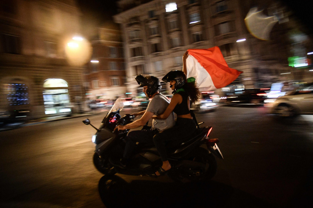 Mereka juga berpawai di jalan-jalan sambil membawa bendera Italia.