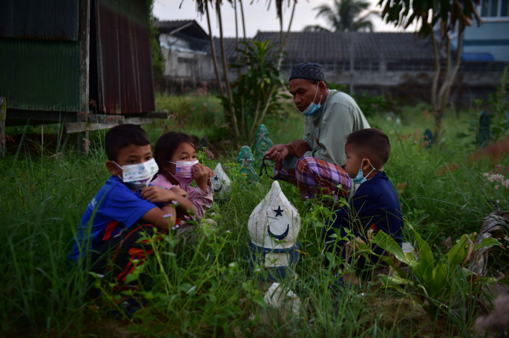 Peziarah mendoakan orang tua dan sanak keluarganya yang telah meninggal ketika berziarah di pemakaman di provinsi selatan Thailand Narathiwat pada 21 Juli 2021. AFP Photo/Madaree Tohlala