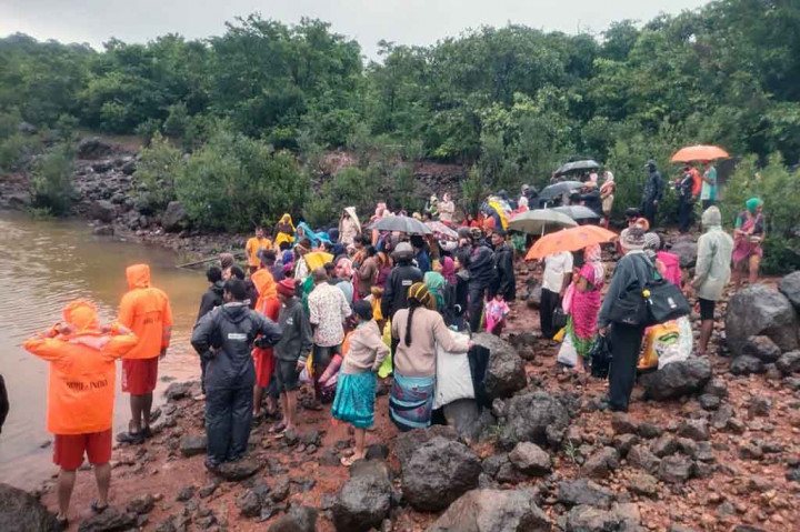 Personel Pasukan Tanggap Bencana Nasional (NDRF) menunggu perahu penyelamat bersama warga korban banjir setelah hujan deras mengguyur wilayah Ambewadi, Distrik Kolhapur, Maharastra.