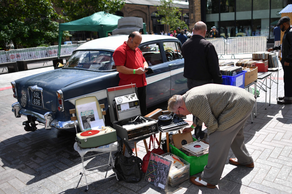 Pelanggan melihat lihat setumpuk piringan hitam di Classic Car Boot Sale, London.