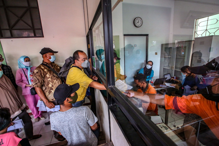 Warga mengantre pendaftaran untuk mengikuti vaksinasi covid-19 saat mobil vaksin keliling singgah di Gedung Balai Kesehatan RS Pondok, Cipinang Muara, Jakarta. Pemerintah Provinsi DKI Jakarta masih terus menggencarkan jemput bola vaksinasi covid-19 melalui program Mobil Vaksin Keliling untuk mempercepat proses vaksinasi dan kekebalan kelompok (herd immunity) terhadap virus korona segera tercapai. 