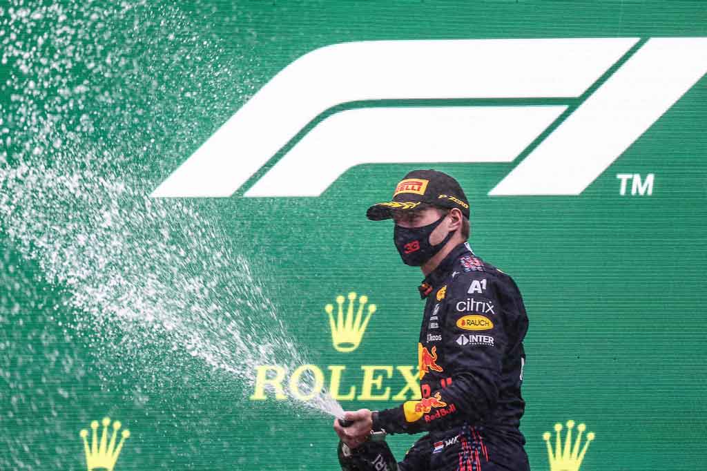 Pembalap Red Bull asal Belanda Max Verstappen menyemprotkan sampanye saat merayakan kemenangannya di Grand Prix Formula Satu Belgia, di sirkuit Spa-Francorchamps, di Spa pada Minggu, 29 Agustus 2021.
