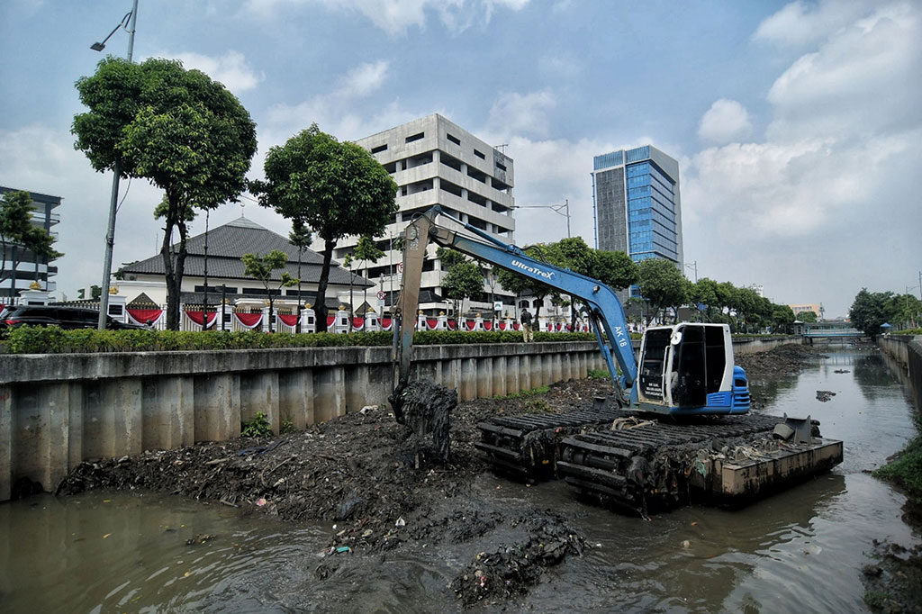 Petugas dari Dinas Sumber Daya Air Jakarta Pusat menggunakan alat berat saat melakukan pengerukan lumpur di Kali Veteran, Gambir, Jakarta Pusat, Selasa, 28 September 2021.