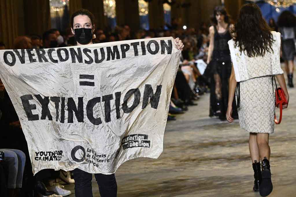 Seorang pengunjuk rasa muncul dan mengganggu peragaan busana Louis Vuitton di Paris pada Selasa, 5 Oktober 2021 waktu setempat. Pengunjuk rasa tersebut berjalan di atas catwalk dengan membentangkan spanduk yang mengutuk dampak konsumsi berlebihan terhadap lingkungan.  