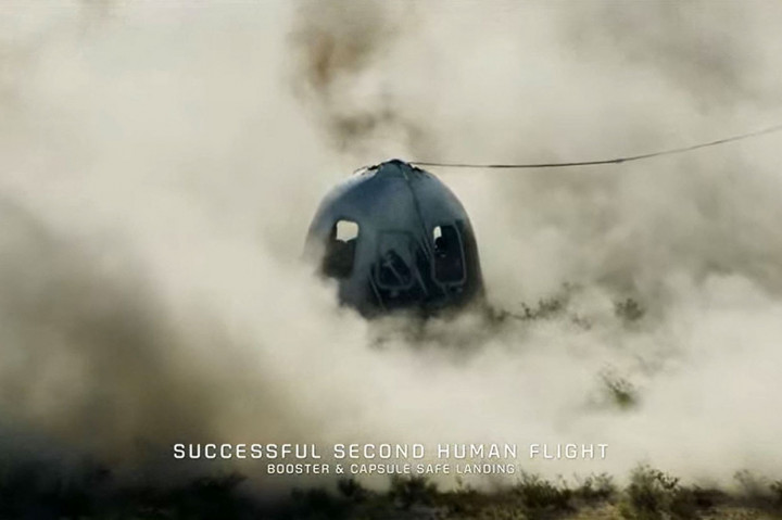 Pendiri Jeff Bezos berada di landasan untuk menyambut anggota kru saat mereka turun dari kapsul, yang mendarat dengan parasut di padang pasir, dan disambut tepuk tangan dan sampanye.