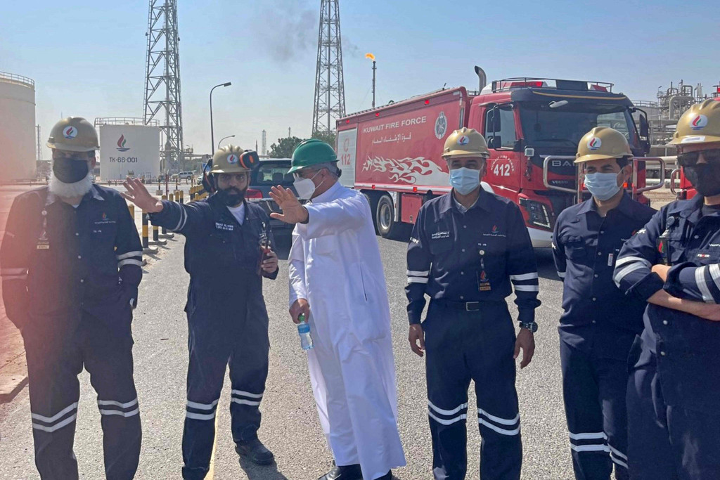 Menteri Perminyakan Kuwait Mohammad al-Fares berkoordinasi dengan petugas pemadam kebakaran di fasilitas Mina al-Ahmadi, sekitar 40 kilometer (25 mil) selatan ibu kota Kuwait City, yang terbakar.