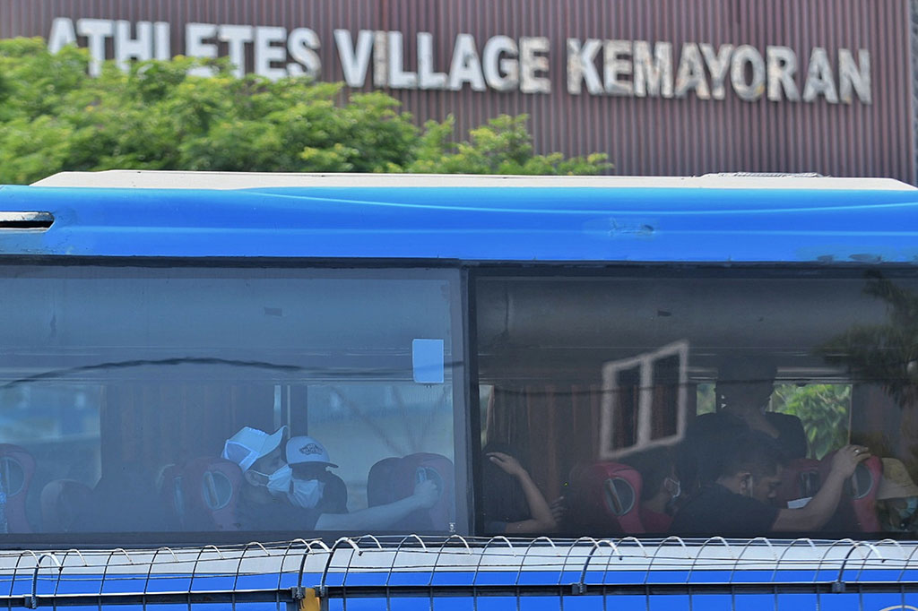 Bus yang mengangkut WNI dari Bandara Soekarno-Hatta nampak antre di depan di Wisma Atlet Kemayoran, Jakarta, Jumat, 17 Desember 2021. 