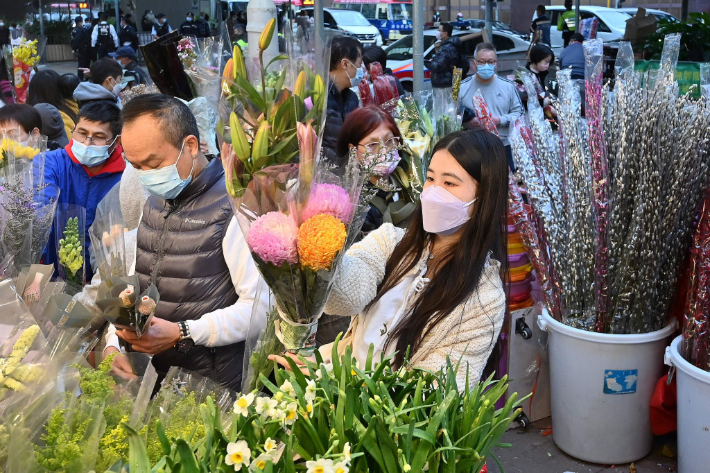 Orang-orang membeli bunga di pasar untuk merayakan Tahun Baru Imlek di Hong Kong, Senin, 31 Januari 2022.