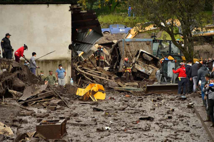 Banjir bandang membawa batu, lumpur, dan puing-puing di jalan-jalan Quito.