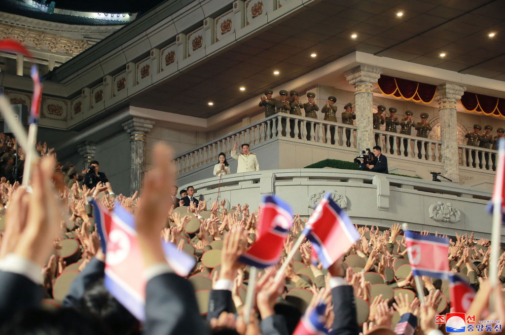 Pemimpin Korea Utara Kim Jong Un didampingi istrinya saat menyaksikan parade militer malam hari untuk memperingati 90 tahun berdirinya Tentara Revolusioner Rakyat Korea di Pyongyang, Korea Utara.