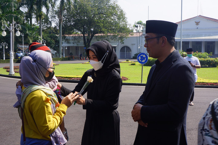 Ratusan warga satu persatu bersalaman dengan Ridwan Kamil dan Atalia secara tertib di dekat pagar Gedung Pakuan. Tak sedikit isak tangis warga pecah ketika bersalaman dengan Ridwan Kamil.