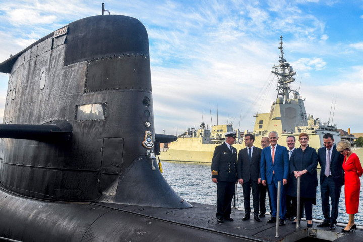 File foto yang diambil pada 2 Mei 2018 menunjukkan Presiden Prancis Emmanuel Macron (2/kiri) dan Perdana Menteri Australia Malcolm Turnbull (tengah) berdiri di dek HMAS Waller, kapal selam kelas Collins yang dioperasikan oleh Angkatan Laut Australia, di Garden Pulau di Sydney.