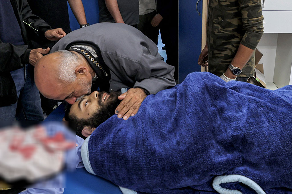 Seorang pria mencium jenazah putranya di sebuah rumah sakit di Salfit di Tepi Barat yang diduduki pada Selasa, 21 Juni 2022. Korban, Ali Harbm 27, meninggal akibat ditikam seorang pemukim Israel di Tepi Barat.