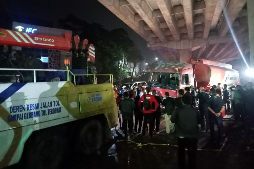 Petugas mengevakuasi tangki Pertamina yang menjadi penyebab kecelakaan maut di Jalan Raya Artenatif Transyogi - Cibubur, RT 01 RW 01, Kelurahan Jatirangga, Kecamatan Jatisampurna, Kota Bekasi, Senin, 18 Juli 2022 malam.