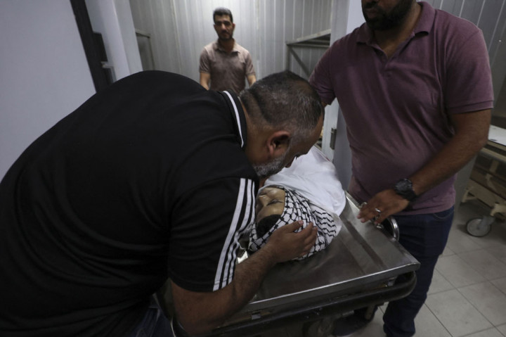 Kerabat berduka di samping jenazah Amjad Abu Alia, remaja Palestina yang terbunuh setelah bentrokan dengan tentara Israel, di sebuah rumah sakit di Ramallah, Tepi Barat yang diduduki, Jumat, 29 Juli 2022.