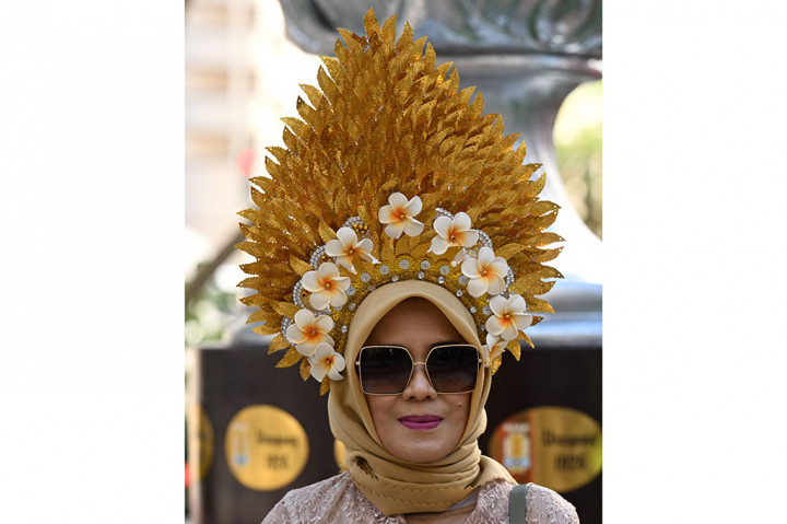 Suporter perempuan Indonesia nampal anggun dengan mengenakan pakaian adat Bali.
